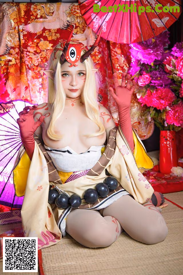 A woman in a kimono sitting on the floor with an umbrella.