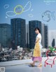 A woman standing on top of a roof next to a drawing of a fish.