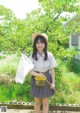 A young woman in a school uniform holding a net.