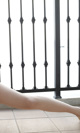 A woman's legs are shown in front of a railing.